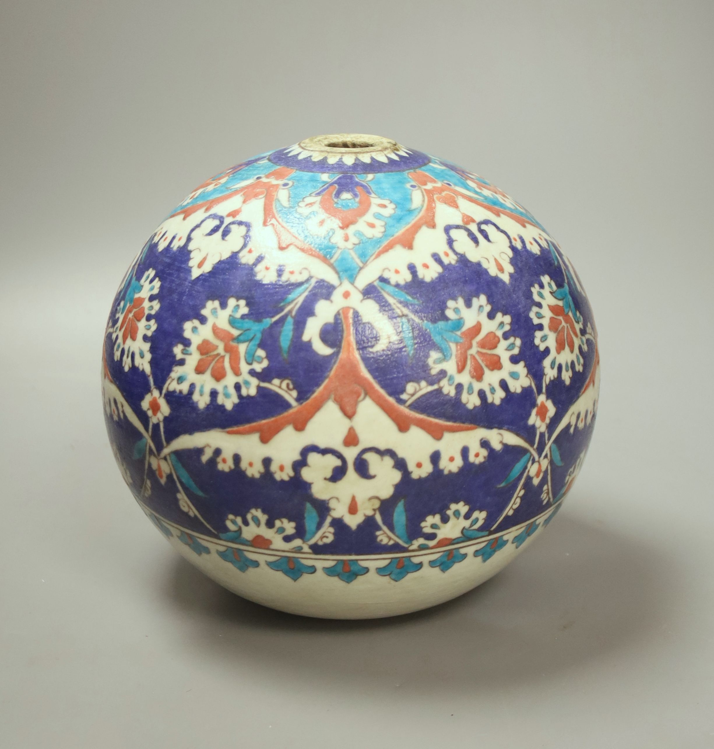 A Turkish Ottoman earthenware hanging mosque bowl, Isnik design, 19cm high
